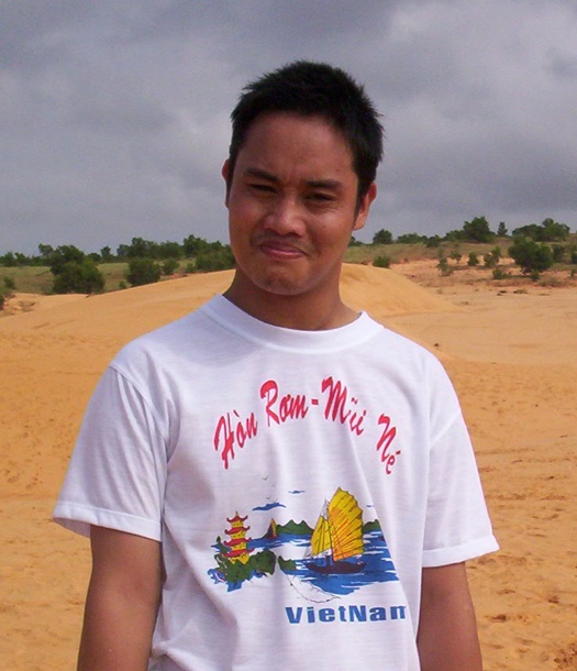 Dom is Viet man in Vietnamese logo tshirt by the beach. 